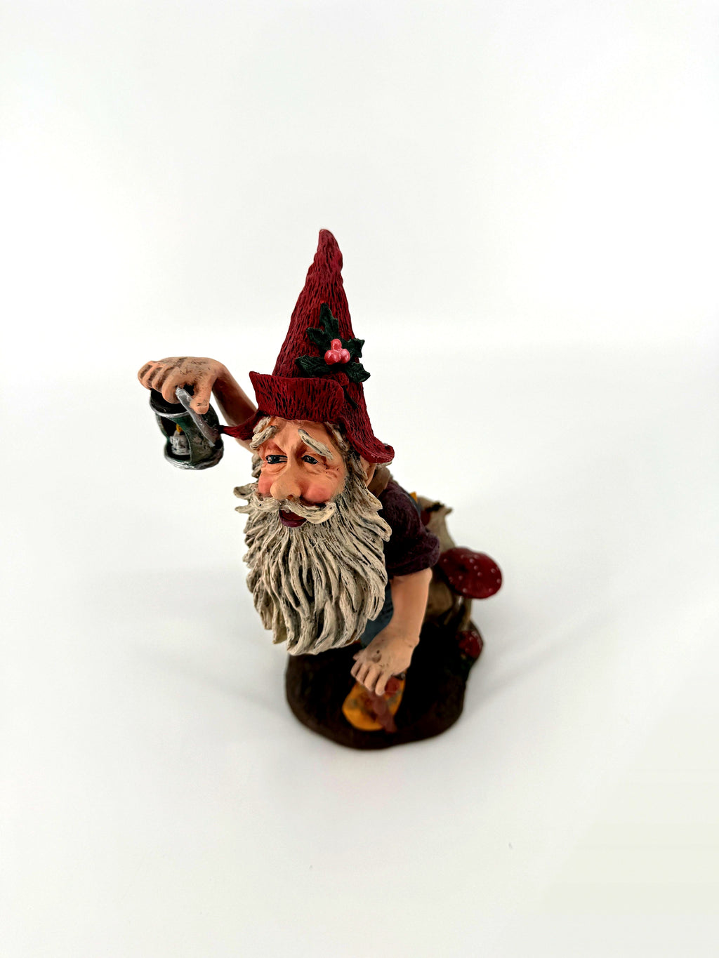 Julenisse three-quarter front view with holly-trimmed red pointed hat