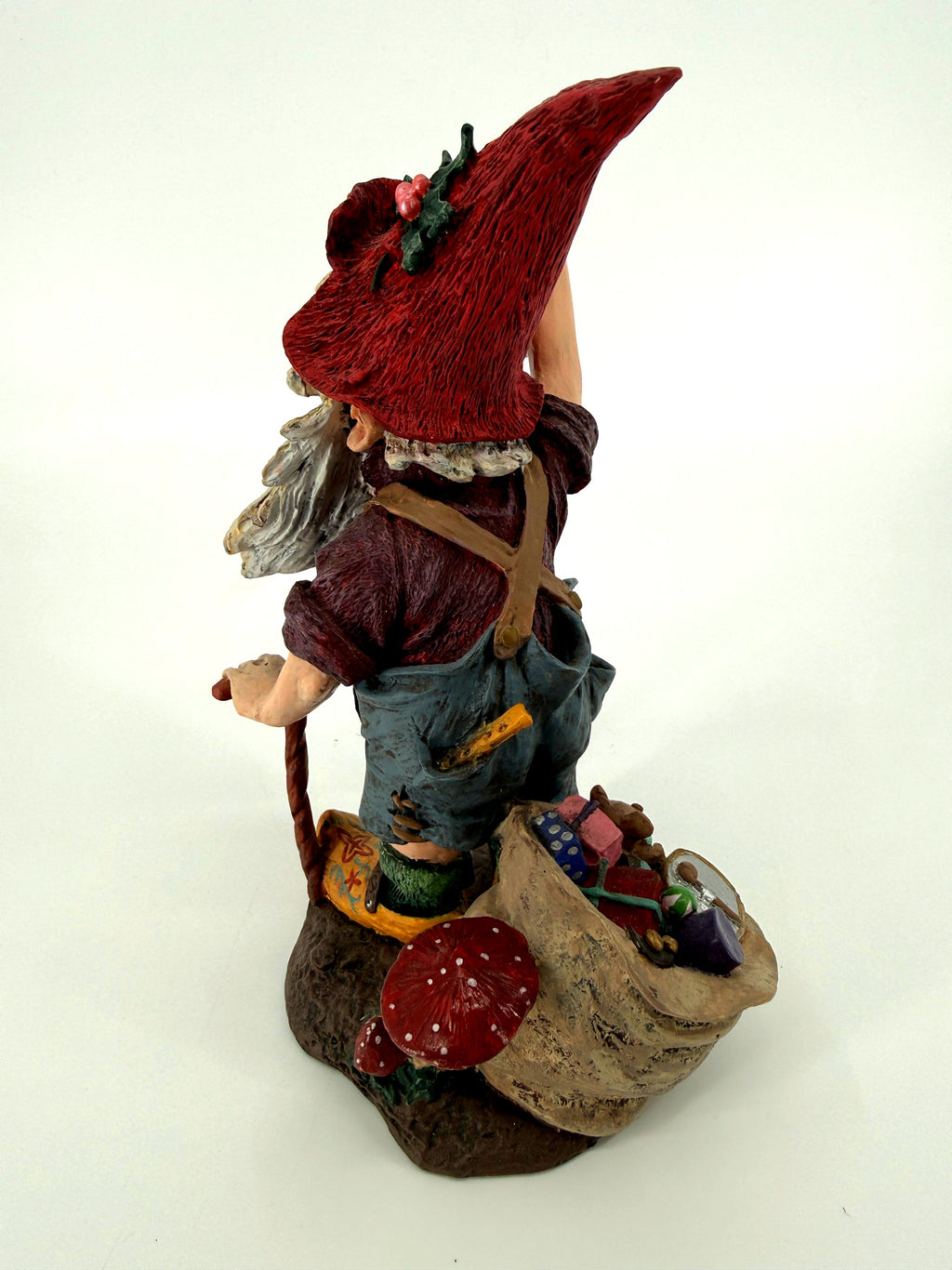 Julenisse back three-quarter view showing cross suspenders and toy sack