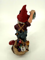 Julenisse rear view with red pointed hat and overflowing gift sack