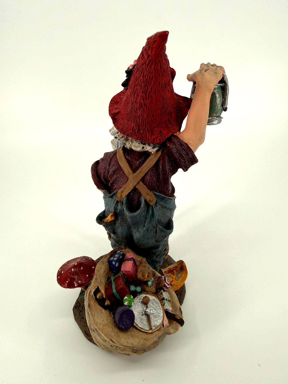 Julenisse rear view with red pointed hat and overflowing gift sack