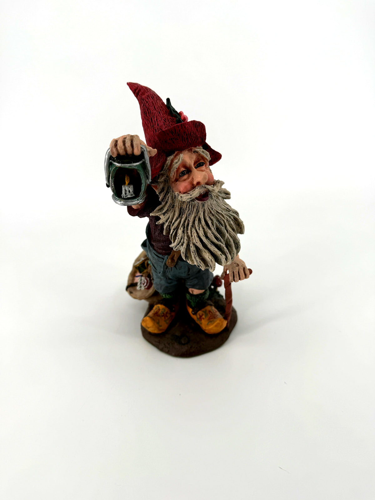 Julenisse figurine front view holding raised lantern with candle
