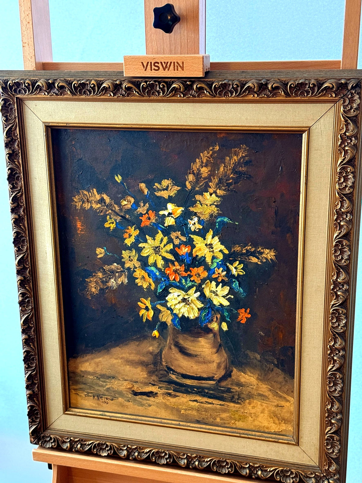 Vintage 1970 K. Nelson floral still life oil painting in ornate gold frame — front view on display easel