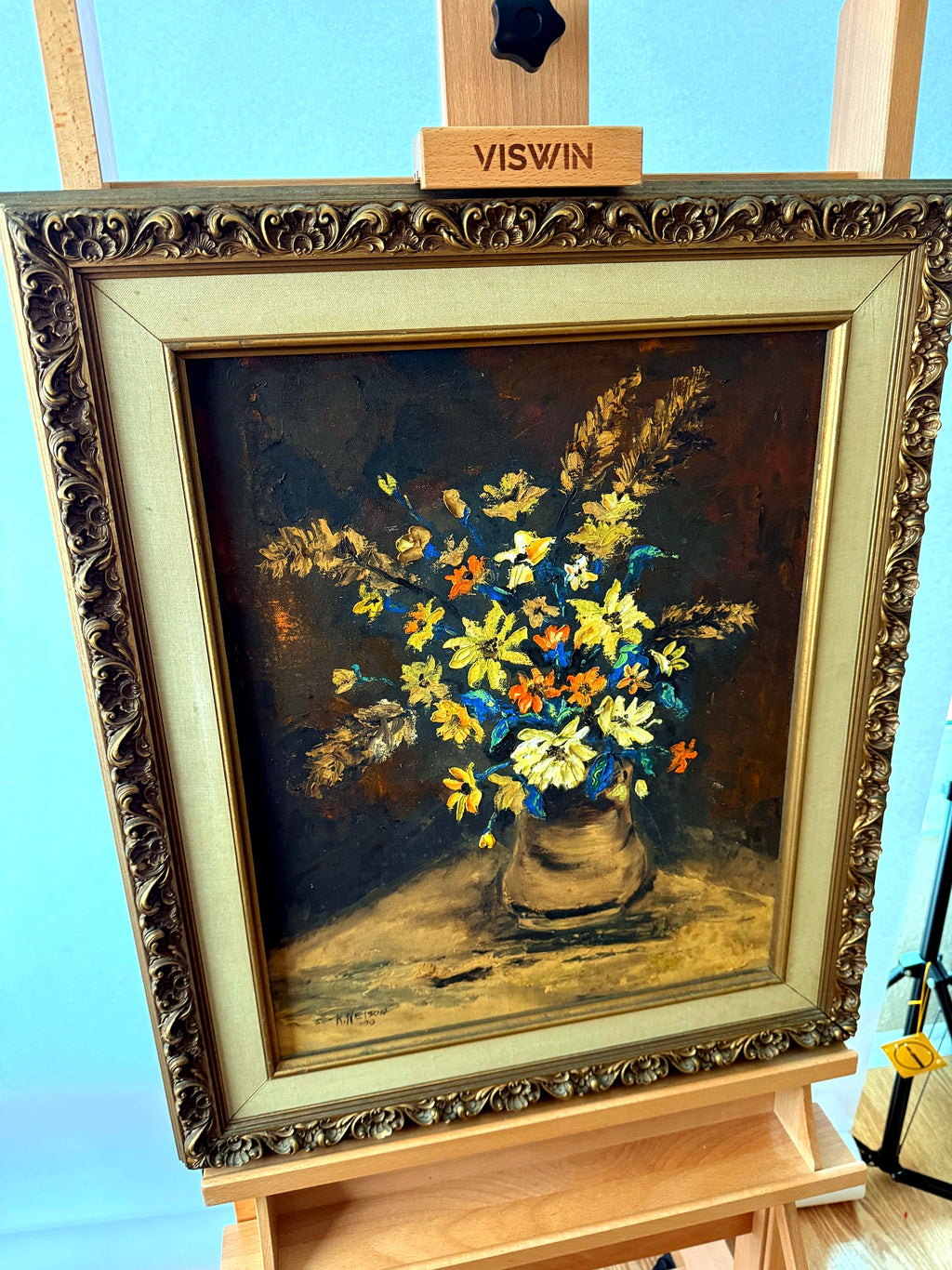 Front view from the right angle on display easel, showing the ornate frame profile
