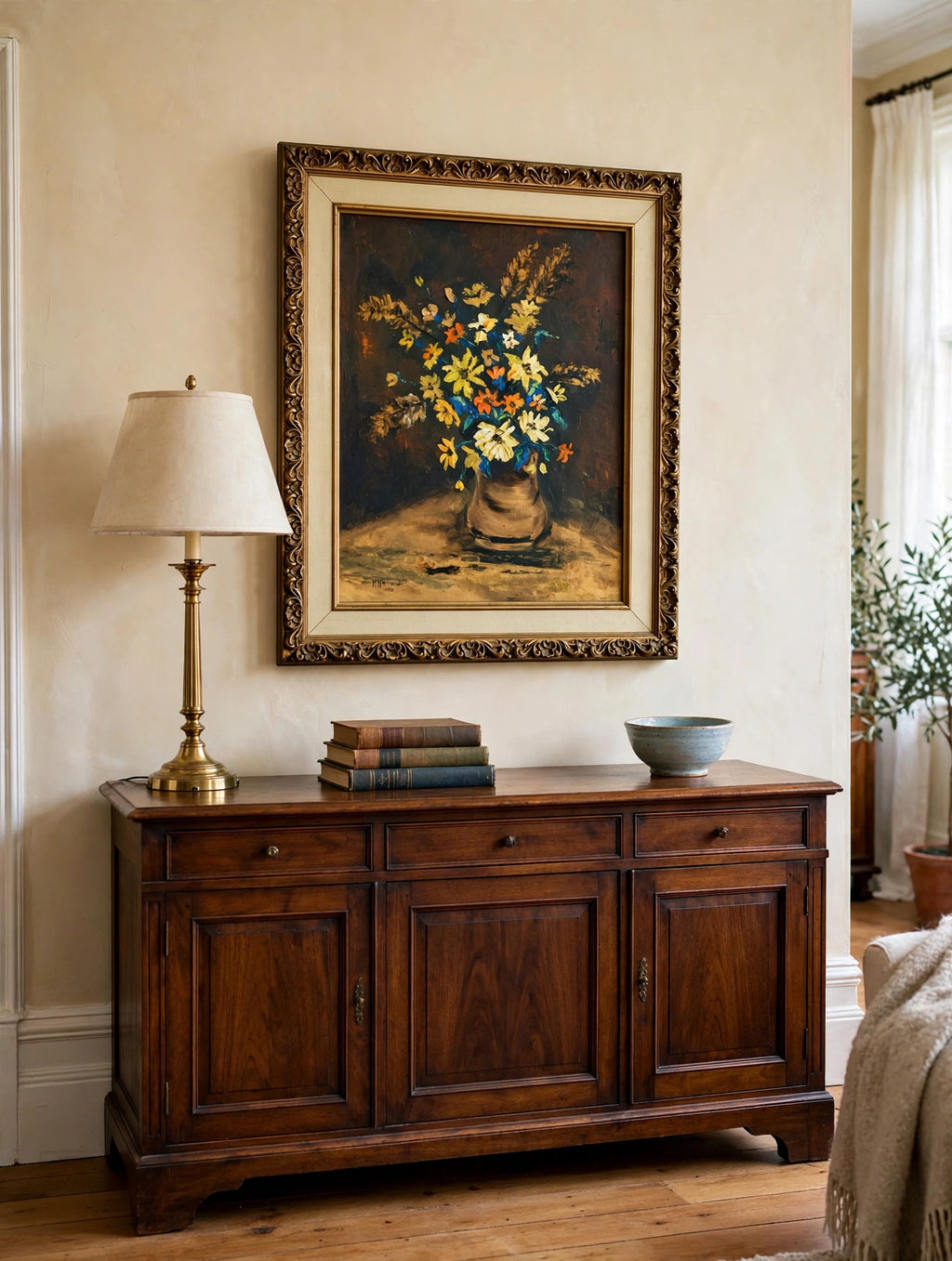 Styled lifestyle photo — the framed K. Nelson floral still life (22.5 × 26.5 in) above a wood sideboard in a traditional living room (display inspiration)