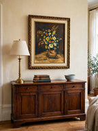 Styled lifestyle photo — the framed K. Nelson floral still life (22.5 × 26.5 in) above a wood sideboard in a traditional living room (display inspiration)