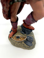 Detail: rocky base with small oil lamp at his feet (enhanced)