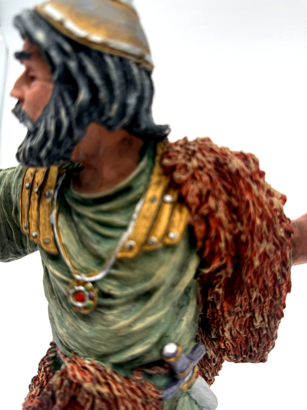 Detail: torso, gold shoulder guards and jeweled pendant (enhanced)