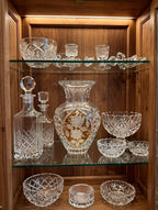 Amber crystal vase on a display cabinet shelf among other crystal pieces (styled display inspiration)