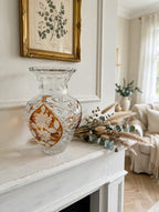 Amber crystal vase on a white mantel with dried grasses and eucalyptus (styled display inspiration)