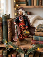 Befana on a bookshelf among antique books with garland and fairy lights (styled display inspiration)