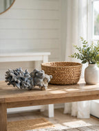 Natural blue-gray branching coral specimen on a sunlit entryway table with a woven basket and greenery (styled display inspiration)