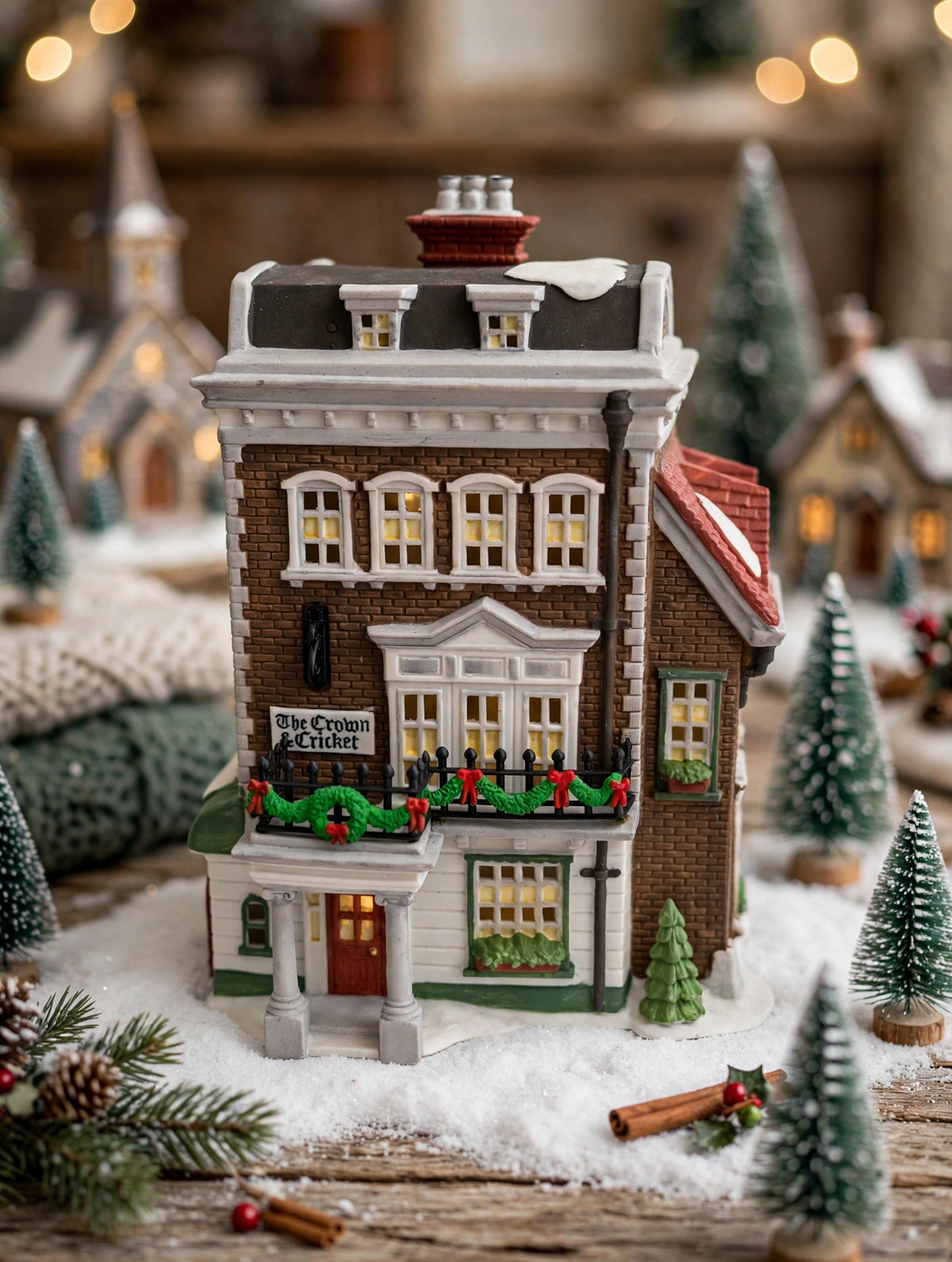 Department 56 Crown & Cricket Inn, Dickens' Village, 1992 First Edition on a snow-blanket Christmas village display with bottle-brush trees (styled display inspiration)