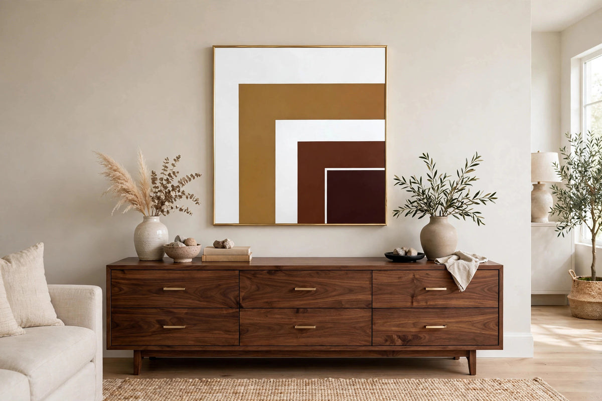 Styled lifestyle photo — the geometric gold mirror hanging at true scale above a walnut credenza in a bright living room (styled display inspiration)