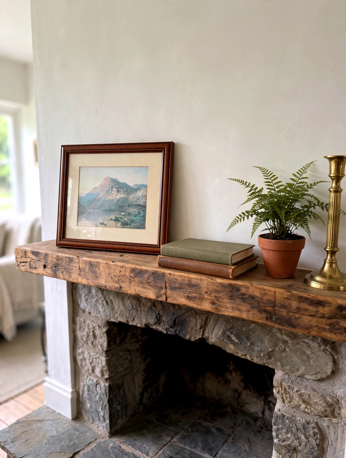 Styled lifestyle photo — the small framed mountain lake print (15.5 × 13.5 in) leaning on a rustic fireplace mantel (display inspiration)