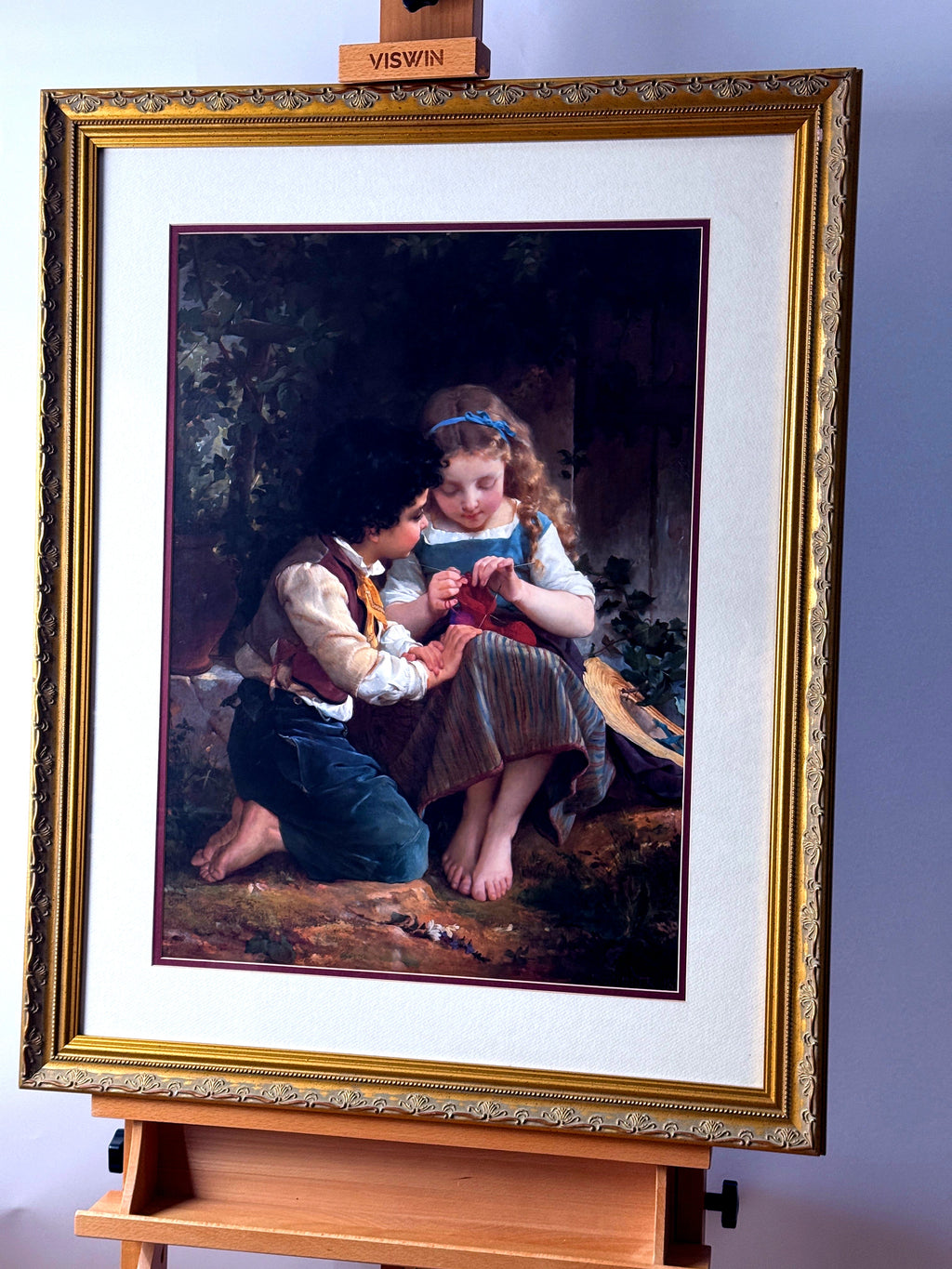 Emile Munier The Knitting Lesson framed art print — front view on an easel