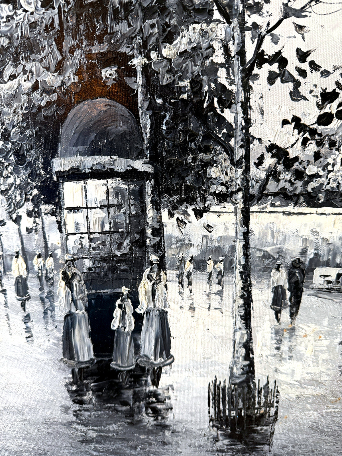 Detail — the advertising column, tree and strollers reflected in the wet pavement in the Paris Notre-Dame street scene