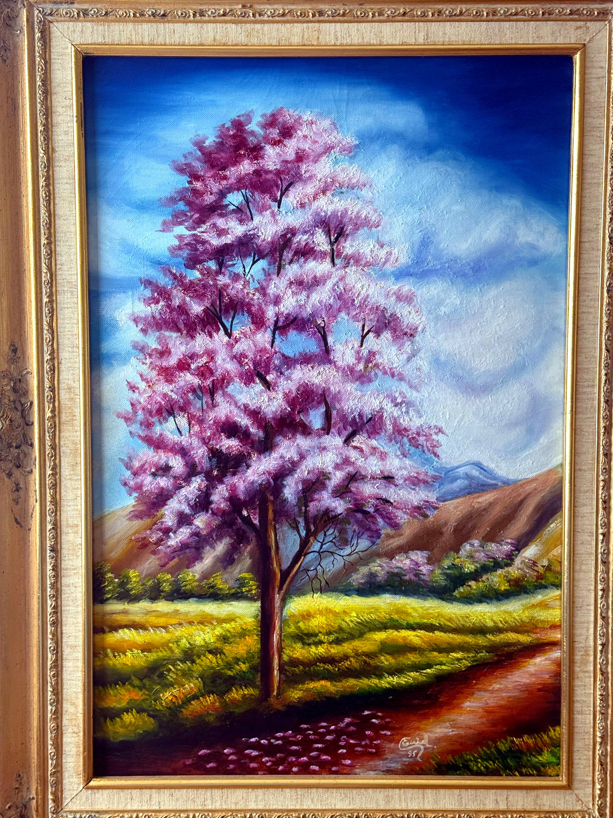 1985 signed oil on canvas pink flowering tree landscape, framed — front view of the painting
