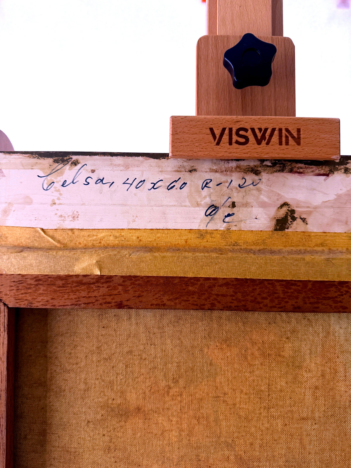 1985 signed oil on canvas pink flowering tree landscape, framed — the back top edge with its handwritten inscription on the canvas fold