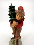 Duncan Royale The Pixie figurine, front view holding snow-dusted Christmas tree (enhanced)