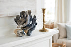 Styled lifestyle photo — the blue coral specimen on a white fireplace mantel in a bright coastal living room (display inspiration)