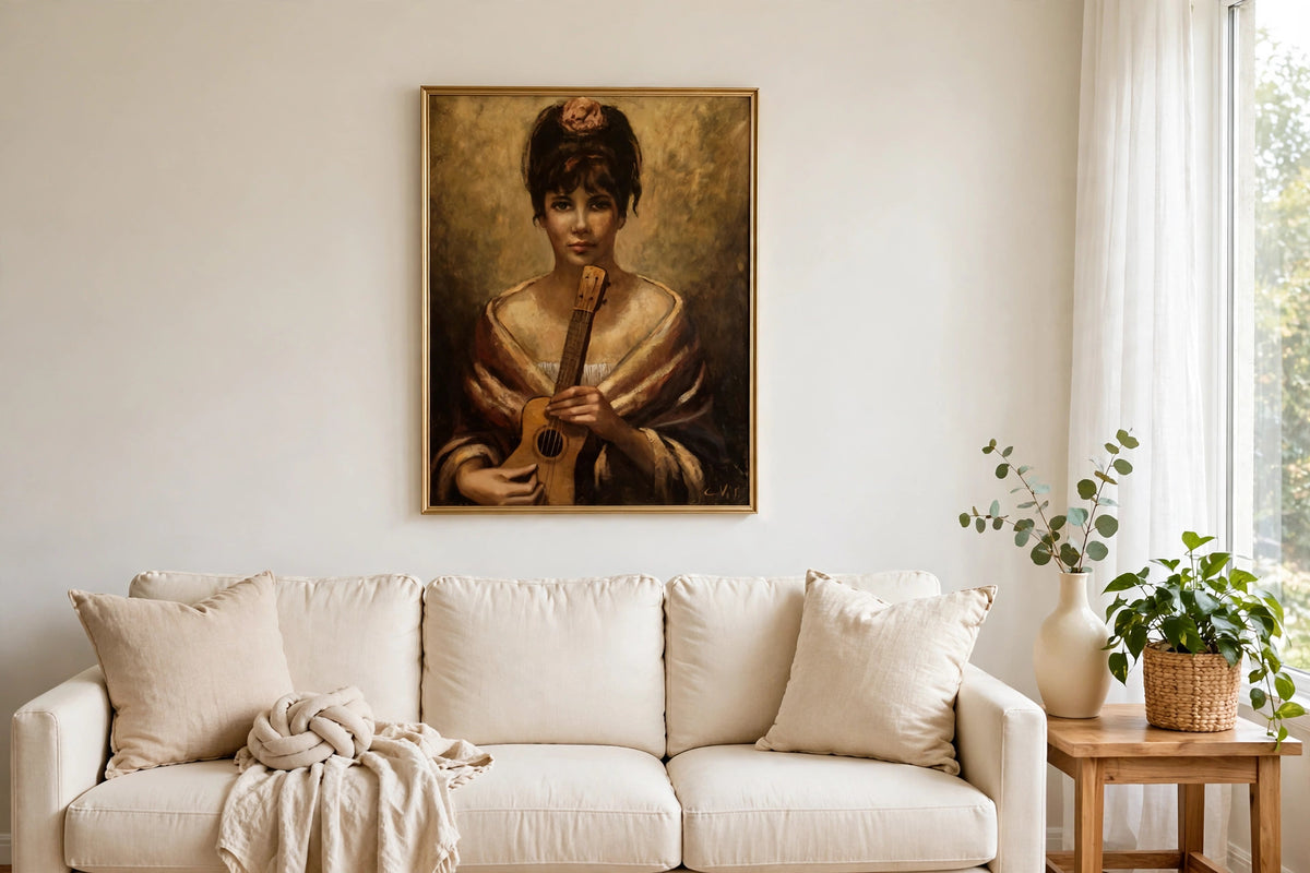 Styled lifestyle photo — the framed Woman with Guitar portrait above a cream sofa in a bright living room (display inspiration)