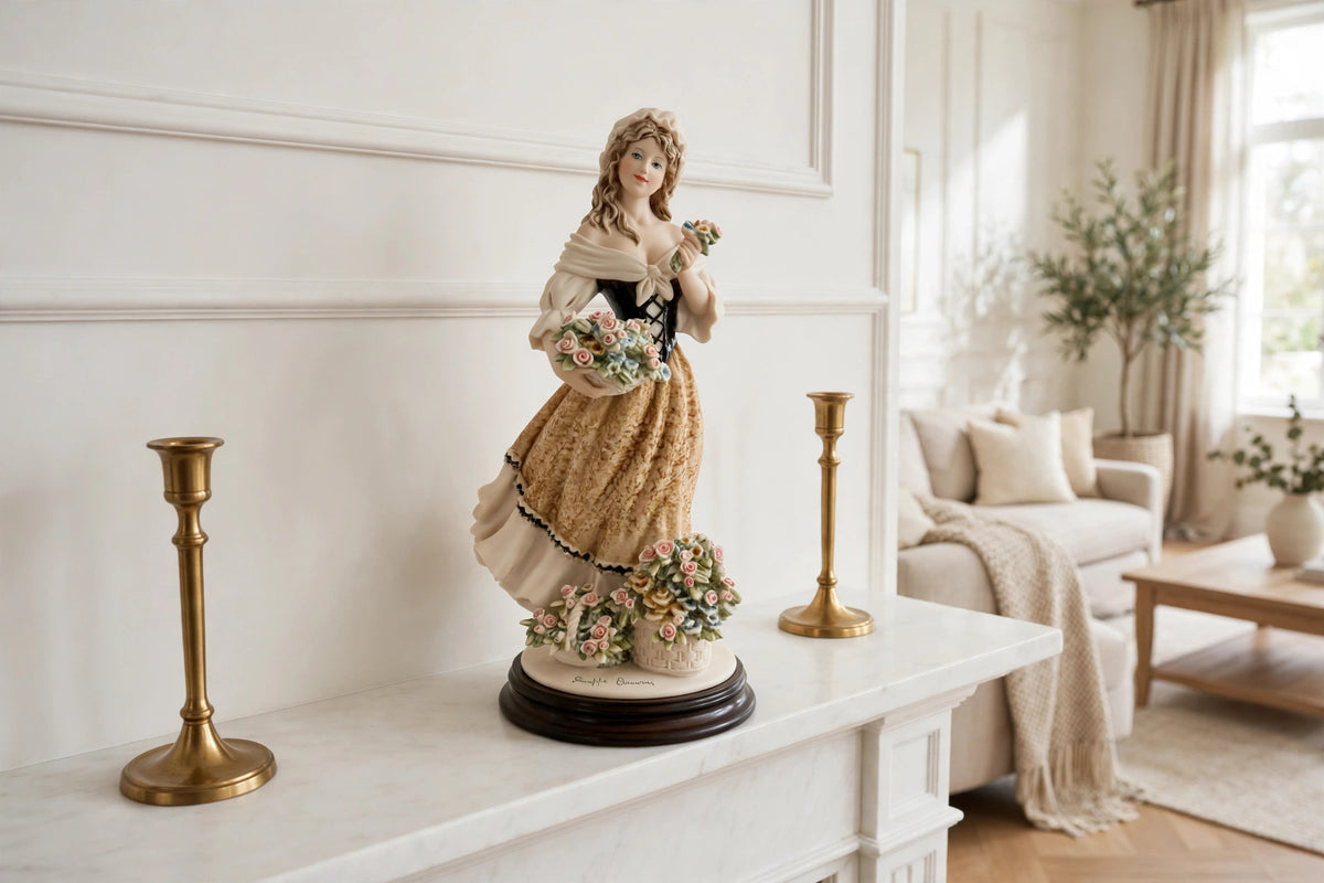 Styled lifestyle photo — the Armani "Roses of May" figurine on a white fireplace mantel with brass candlesticks in a bright living room (display inspiration)