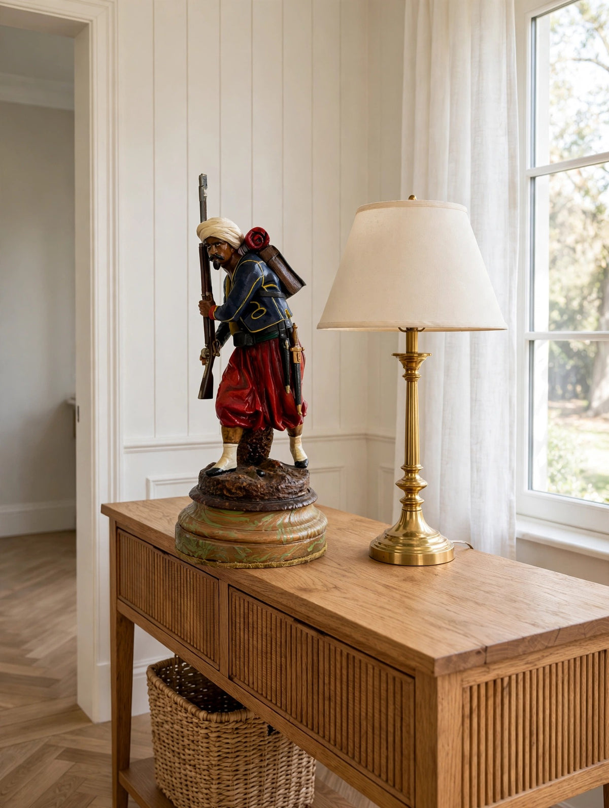 Styled lifestyle photo — the Zouave soldier statue on a wooden console table in a bright entryway (display inspiration)