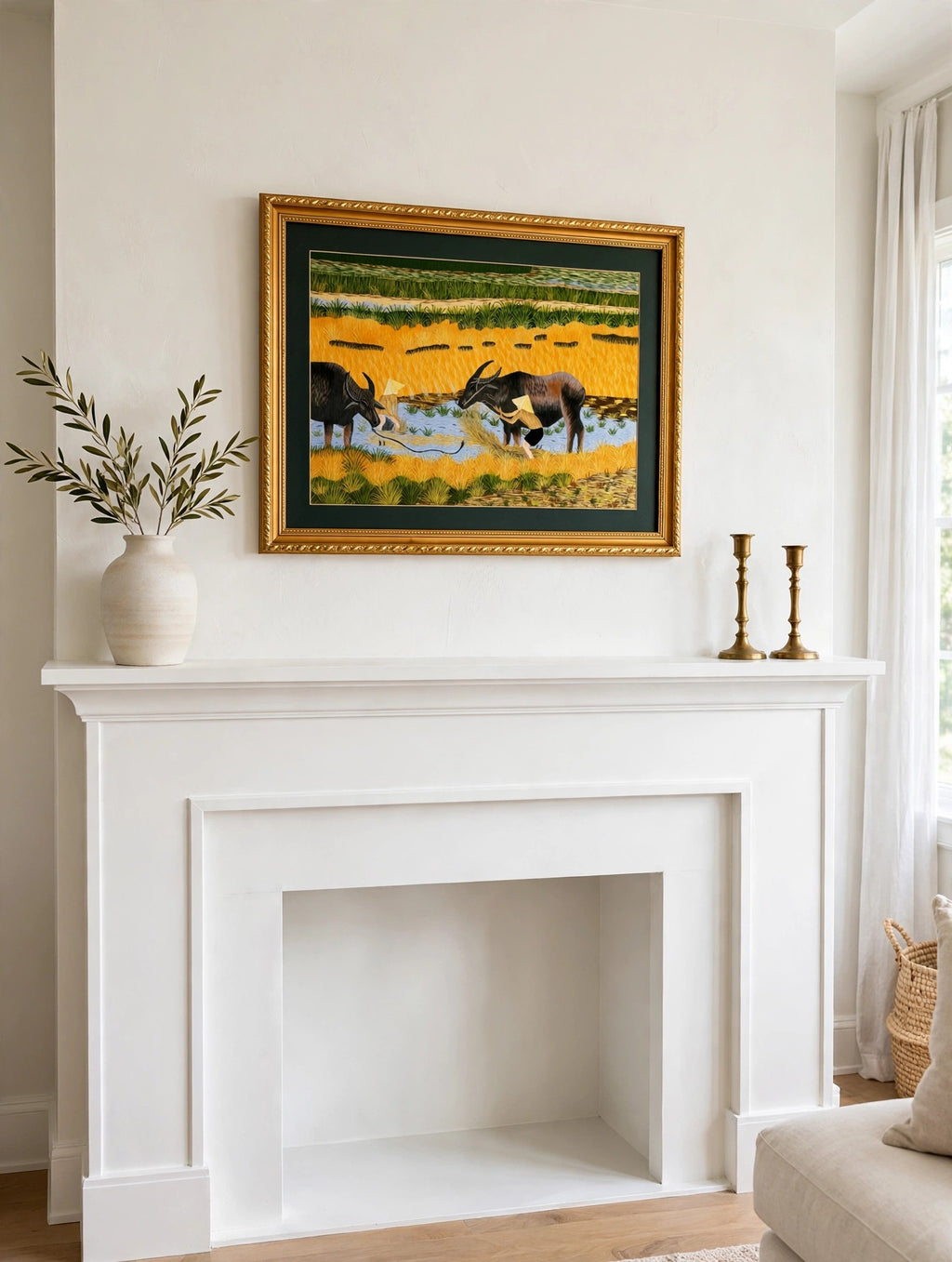 Styled lifestyle photo — the framed Vietnamese embroidery above a white fireplace mantel in a bright living room (display inspiration)