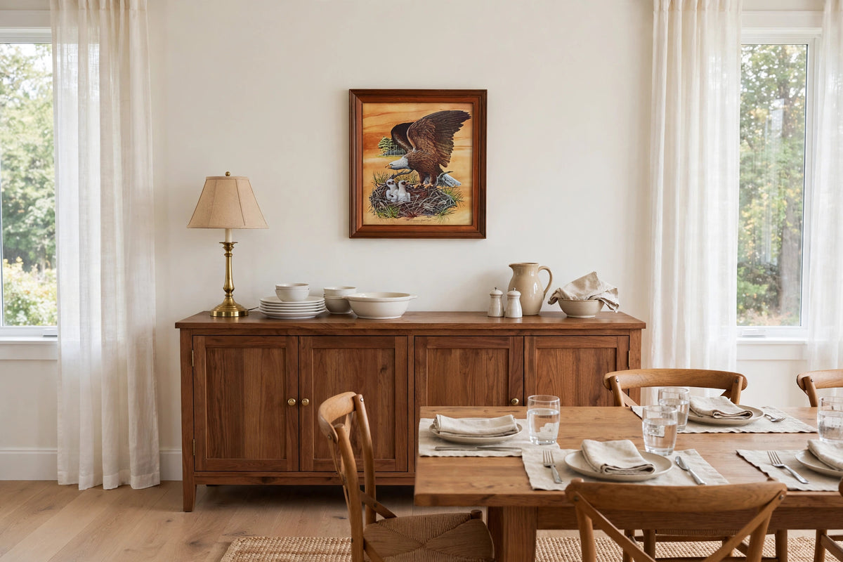 Styled lifestyle photo — the framed Robert Nipp bald eagle print above a wooden sideboard in a bright dining room (display inspiration)