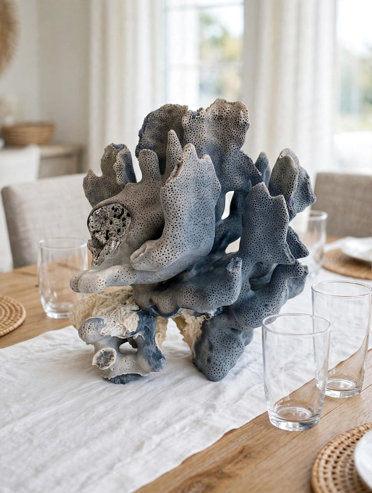 Styled lifestyle photo — the blue coral specimen as a centerpiece on a dining table in a bright dining room (display inspiration)