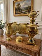 Samovar collection styled on a carved console table in an entry hall (display inspiration)
