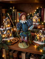 Lord of Misrule displayed on a bookshelf with lit Christmas village houses - display inspiration