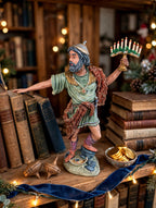 Judah Maccabee displayed on a bookshelf with dreidels and a bowl of gelt - display inspiration