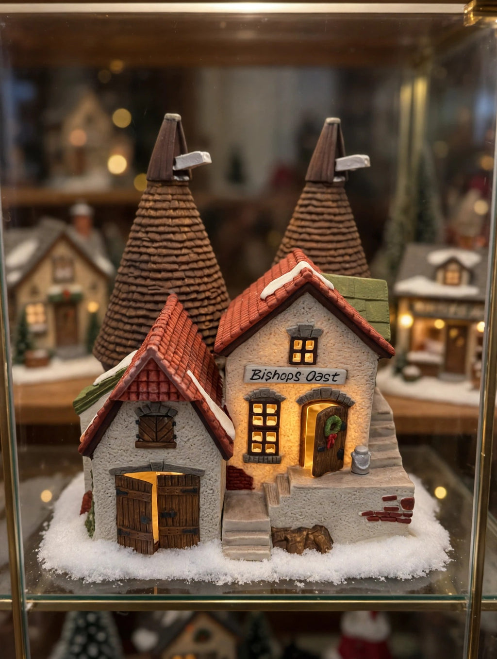Bishops Oast House in a styled display cabinet Christmas village scene (display inspiration; only the building is included)