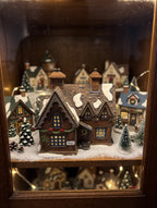 Barmby Moor Cottage in a styled display cabinet Christmas village scene (display inspiration; only the cottage is included)