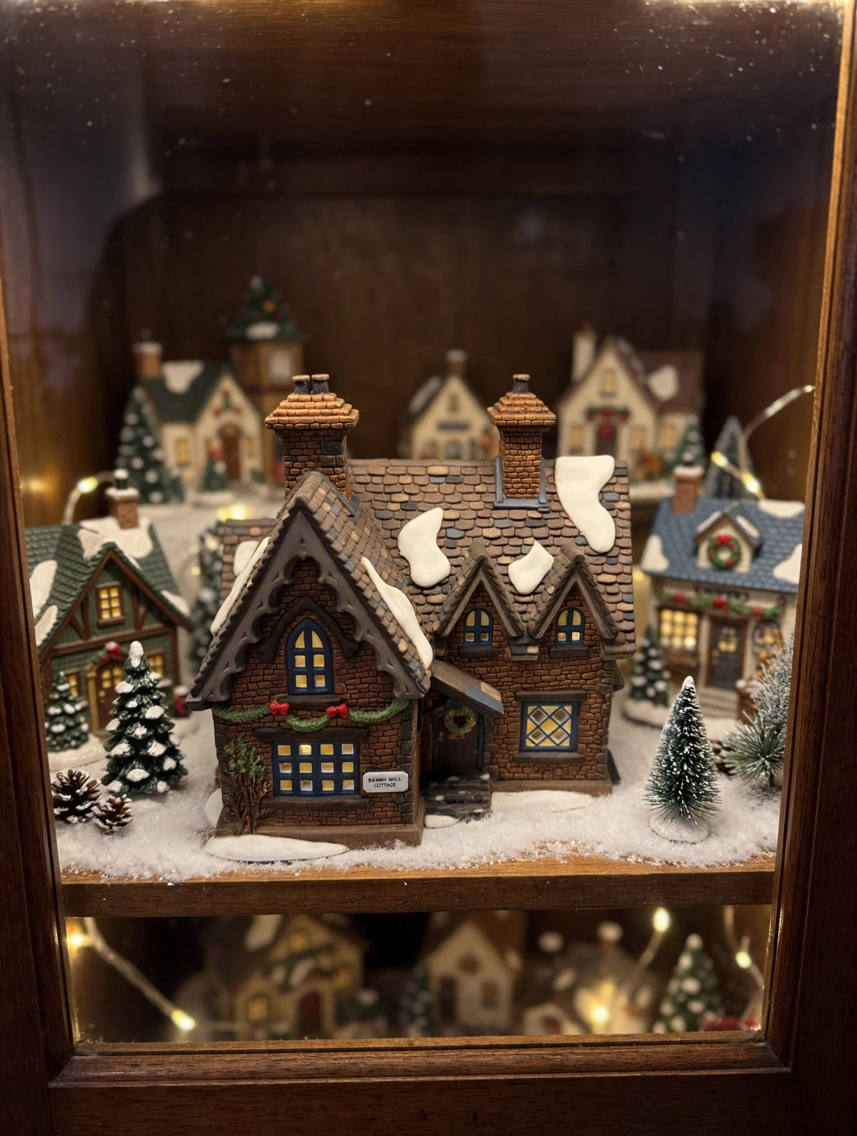 Barmby Moor Cottage in a styled display cabinet Christmas village scene (display inspiration; only the cottage is included)