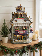 Williamson's Garden Shoppe styled on an entry console with a potted evergreen and candles — styled scene, display inspiration only (enhanced photo)