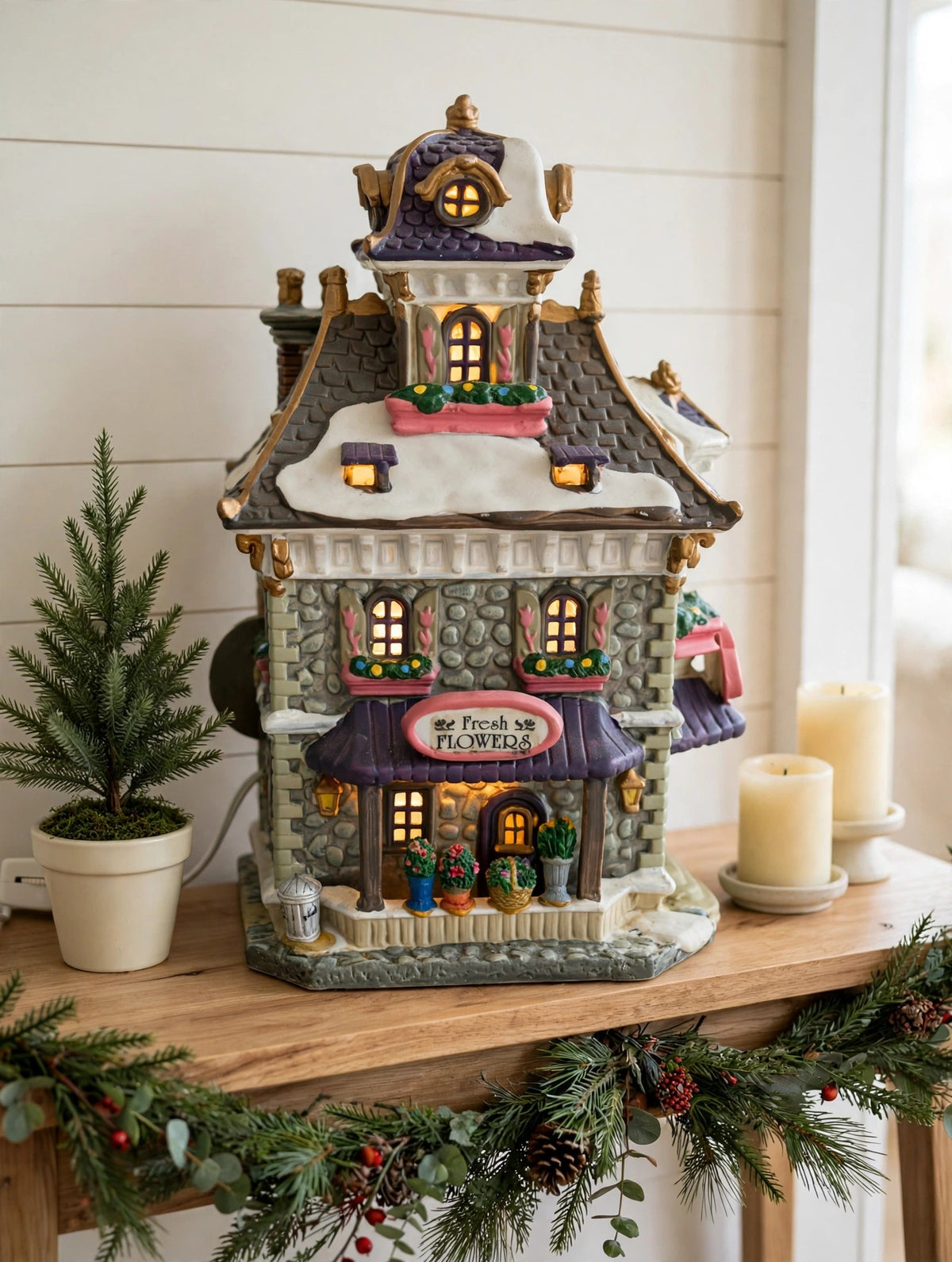 Williamson's Garden Shoppe styled on an entry console with a potted evergreen and candles — styled scene, display inspiration only (enhanced photo)