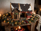 Department 56 Dickens' Village Butter Tub Barn #58338 – shown on a Christmas mantel with garland, pine cones and fairy lights (styled display inspiration)