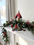 Department 56 Christmas Bells, 1996 Special Event Piece, Heritage Village Collection – shown on a bright Christmas mantel with garland and pine cones (styled display inspiration)