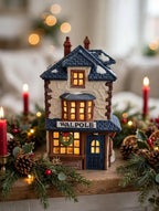 Department 56 Dickens' Village Walpole Tailors #5926-9 — styled scene: lit on a Christmas mantel with garland and red candles (display inspiration)