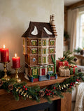 Department 56 Nephew Fred's Flat, Dickens' Village, 1991 – shown on a Christmas mantel with candles and garland (styled display inspiration)