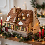 Department 56 Dickens' Village The Christmas Carol Cottage #58339 — styled scene generated from the reference photo: lit on a Christmas mantel with garland and red candles (display inspiration) — shown for visual interpretation only; not the actual item
