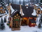 Department 56 Dickens' Village Butter Tub Barn #58338 – shown glowing in a snowy miniature village square at dusk (styled display inspiration)
