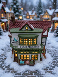 Department 56 Dickens' Village The Mermaid Fish Shoppe #5926-9 — styled scene: lit on a snowy Christmas village street (display inspiration)