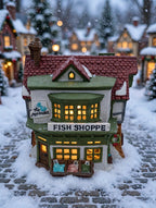 Department 56 Dickens' Village The Mermaid Fish Shoppe #5926-9 — styled scene: lit on a snowy Christmas village street (display inspiration)