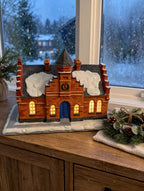 Hawthorne The Town Offices Norman Rockwell Christmas in Stockbridge 1993 — styled scene: lit on a wooden sideboard by a frosted window at dusk (display inspiration)