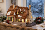 Department 56 Dickens' Village The Christmas Carol Cottage #58339 — styled scene generated from the reference photo: lit on a wooden sideboard by a frosted window at dusk (display inspiration) — shown for visual interpretation only; not the actual item