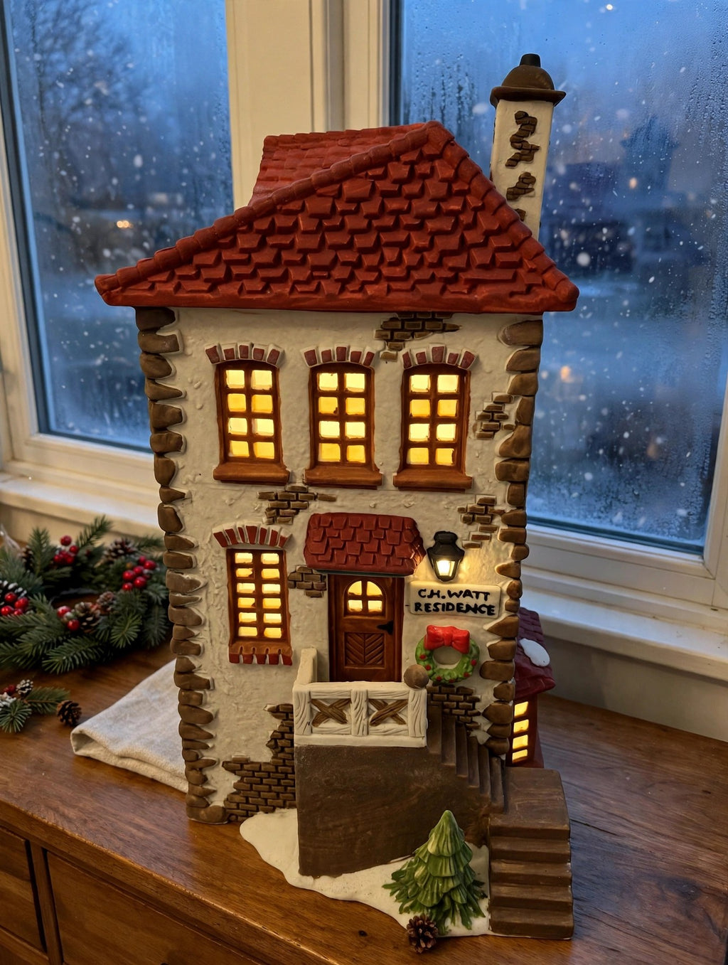 Department 56 Dickens' Village C. H. Watt Physician #5568-9 — styled scene: lit on a wooden sideboard by a frosted window at dusk (display inspiration)