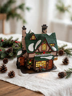 Styled photo - Quilly's Antiques on a holiday table with greenery (display inspiration)